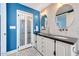 Beautiful bathroom featuring double sinks, granite countertop, decorative mirrors, and stylish tiling at 9621 N 83Rd Way, Scottsdale, AZ 85258