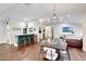 Elegant dining area with a bar, hardwood floors, and modern chandelier at 9621 N 83Rd Way, Scottsdale, AZ 85258