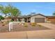Single-story home with desert landscaping, warm paint, and a convenient two-car garage at 9621 N 83Rd Way, Scottsdale, AZ 85258