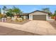 This charming one story home features desert landscaping, warm paint and a convenient two-car garage at 9621 N 83Rd Way, Scottsdale, AZ 85258