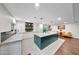Well-lit kitchen with a spacious island, white cabinetry, and hardwood flooring at 9621 N 83Rd Way, Scottsdale, AZ 85258