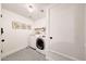 Clean laundry room with a front load washer and dryer, decor, and cabinet storage at 9621 N 83Rd Way, Scottsdale, AZ 85258