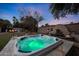 Relaxing backyard spa area with a built-in water feature and comfortable lounge furniture at 9621 N 83Rd Way, Scottsdale, AZ 85258