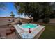 Backyard spa area, offering a tranquil escape with lush landscaping, seating, and ambient lighting at 9621 N 83Rd Way, Scottsdale, AZ 85258