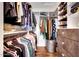 Well-organized walk-in closet with shelving, hanging rods, drawers, and hardwood floors at 9621 N 83Rd Way, Scottsdale, AZ 85258