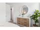 Comfortable bedroom features a dresser, round mirror and a plant, creating a warm and inviting space at 9835 S 11Th St, Phoenix, AZ 85042