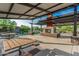 Open-air community pavilion with picnic tables and a stone fireplace, perfect for outdoor gatherings and relaxation at 9835 S 11Th St, Phoenix, AZ 85042