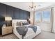 Elegant main bedroom featuring panel wall, modern lighting, and large windows with view at 9835 S 11Th St, Phoenix, AZ 85042