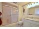 Bathroom with a shower, updated vanity, neutral colors, and a well-lit mirror at 10334 W Highwood Ln, Sun City, AZ 85373