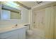 Bathroom featuring a shower-tub combo, a vanity with a large mirror, and a tiled floor at 10334 W Highwood Ln, Sun City, AZ 85373