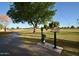 Picturesque view of the golf course with manicured lawn, mature trees, and clear blue skies at 10334 W Highwood Ln, Sun City, AZ 85373