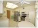 Bright kitchen featuring stainless steel appliances, white cabinets, and an adjacent dining area at 10334 W Highwood Ln, Sun City, AZ 85373