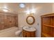 Cozy bathroom featuring a tiled shower-tub combo and vintage style vanity at 10421 N 77Th Pl, Scottsdale, AZ 85258