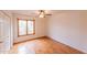 Light-filled bedroom with hardwood floors and a window showcasing the outside greenery at 10421 N 77Th Pl, Scottsdale, AZ 85258