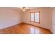 Cozy bedroom with hardwood floors, a ceiling fan, and a window with natural light at 10421 N 77Th Pl, Scottsdale, AZ 85258