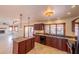 Spacious kitchen with granite countertops, dark wood cabinets, and an island at 10421 N 77Th Pl, Scottsdale, AZ 85258