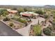 An aerial view of the property showcasing landscaping, solar panels, and a circular driveway at 10955 E Vista Del Cielo Rd, Gold Canyon, AZ 85118