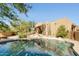 Backyard pool reflecting home and spiral staircase, enhanced by desert landscaping at 10955 E Vista Del Cielo Rd, Gold Canyon, AZ 85118