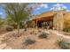 Outdoor backyard space featuring natural desert landscaping, a stone patio and exterior spiral staircase at 10955 E Vista Del Cielo Rd, Gold Canyon, AZ 85118