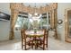 Charming dining area with a round table, floral curtains, and natural light at 10955 E Vista Del Cielo Rd, Gold Canyon, AZ 85118