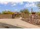 Spacious circular driveway leading to a private desert home with stone accents and desert landscaping at 10955 E Vista Del Cielo Rd, Gold Canyon, AZ 85118