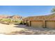 Exterior shot featuring a two-car garage, iron gated entrance, and mountain views at 10955 E Vista Del Cielo Rd, Gold Canyon, AZ 85118