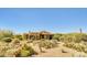 Outdoor shot of a single-story home featuring mature desert landscaping and a tile roof at 10955 E Vista Del Cielo Rd, Gold Canyon, AZ 85118