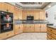 Traditional style kitchen featuring wooden cabinets, granite countertops, and black appliances at 10955 E Vista Del Cielo Rd, Gold Canyon, AZ 85118