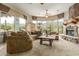 Comfortable living room with a stone fireplace, large windows, and mountain views at 10955 E Vista Del Cielo Rd, Gold Canyon, AZ 85118