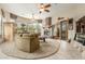 Spacious living room featuring a stone fireplace, large windows, and stylish decor at 10955 E Vista Del Cielo Rd, Gold Canyon, AZ 85118