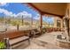 Inviting covered patio boasting desert views, an outdoor seating area, and a water feature at 10955 E Vista Del Cielo Rd, Gold Canyon, AZ 85118