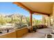 Covered patio featuring desert landscaping and mountain views from this luxury home at 10955 E Vista Del Cielo Rd, Gold Canyon, AZ 85118