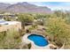 A large swimming pool with waterfall feature in a desert home setting at 10955 E Vista Del Cielo Rd, Gold Canyon, AZ 85118