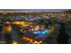 Nighttime aerial view of community center with a pool illuminated in vibrant blue and surrounded by seating at 1119 E Mcneil St, Phoenix, AZ 85042