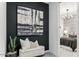 Hallway with artwork leading into a bedroom with a chandelier and patterned wallpaper at 1119 E Mcneil St, Phoenix, AZ 85042