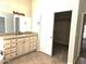 Bathroom vanity with granite countertop, ample storage, and a view into the walk-in closet at 1119 E Southshore Dr, Gilbert, AZ 85234