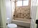 Bathroom featuring a tiled shower-tub, a shower head, and a toilet at 1119 E Southshore Dr, Gilbert, AZ 85234