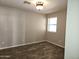 This bedroom features wood-look floors, neutral paint, a window, and a decorative ceiling light at 1119 E Southshore Dr, Gilbert, AZ 85234