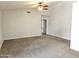 Spacious bedroom with neutral carpet, ceiling fan, and an adjacent closet at 1119 E Southshore Dr, Gilbert, AZ 85234