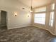 Dining room featuring wood-look tile flooring, neutral walls, modern lighting, and large windows at 1119 E Southshore Dr, Gilbert, AZ 85234