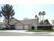 Angle view of a home with a large, well-maintained lawn, an attached three-car garage, and mature trees at 1119 E Southshore Dr, Gilbert, AZ 85234