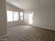 Bright living room with neutral carpet and large windows, providing ample natural light at 1119 E Southshore Dr, Gilbert, AZ 85234