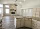 Spacious living room with wood-look tile, granite counters, and stone fireplace at 1119 E Southshore Dr, Gilbert, AZ 85234