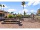 This property has a spacious yard with mature trees, custom fencing, and decorative landscaping features at 11820 S Half Moon Dr, Phoenix, AZ 85044