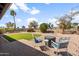 Landscaped backyard featuring a patio, artificial turf, and decorative rock, creating a serene outdoor space at 11820 S Half Moon Dr, Phoenix, AZ 85044