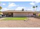 Spacious backyard featuring mature landscaping, a covered patio, artificial turf, and rock features at 11820 S Half Moon Dr, Phoenix, AZ 85044