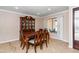 Elegant dining room with a classic china cabinet and a window view at 11820 S Half Moon Dr, Phoenix, AZ 85044