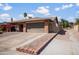 Charming single-Gathering home featuring brick accents, a well-maintained yard, and a two-car garage at 11820 S Half Moon Dr, Phoenix, AZ 85044