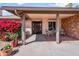 Covered front porch with seating area and beautiful bougainvillea at 11820 S Half Moon Dr, Phoenix, AZ 85044