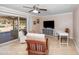 Bright living room with tile floors, ceiling fan, access to the backyard, and neutral walls at 11820 S Half Moon Dr, Phoenix, AZ 85044